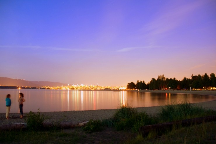 Downtown lights reflecting off the still waters of Spanish Banks
